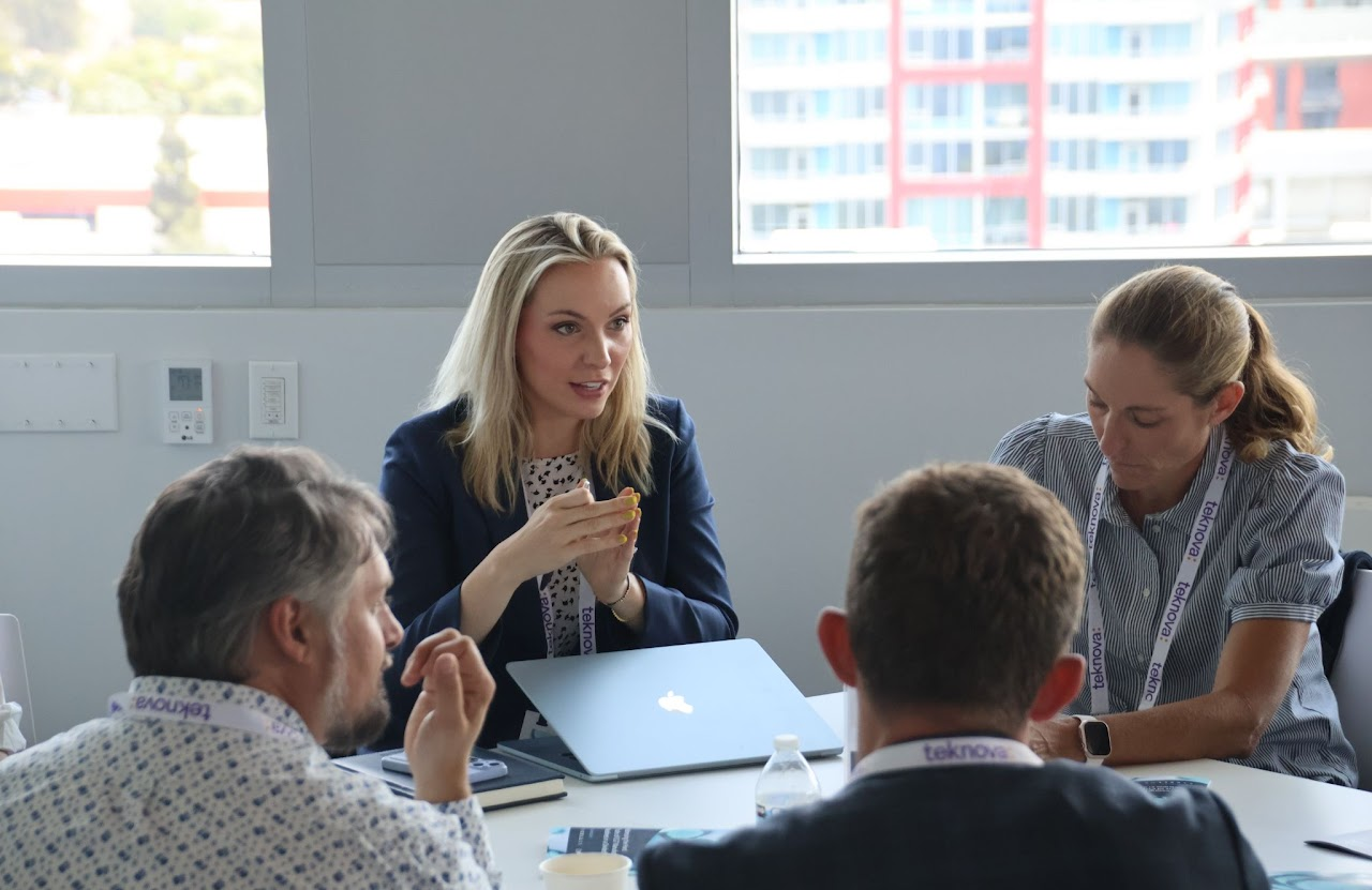 Group of colleagues greeting each other in a stylized blue duotone treatment